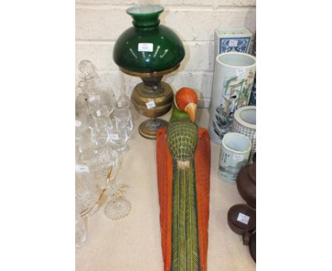 A brass oil lamp with green glass shade, a modern carved wooden parrot and a fencing foil, (3).