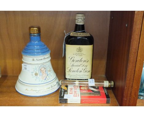 An old bottle of Gordon's Special Dry London Gin, with original labels, foil and spring cap, a commemorative ceramic whisky b