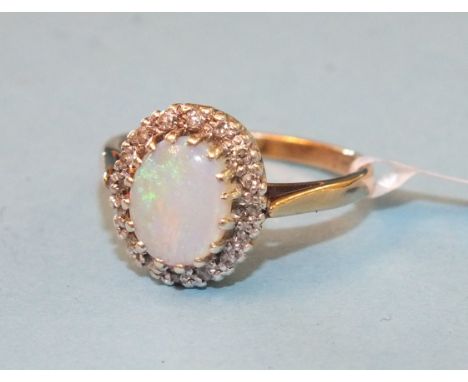 An opal and diamond cluster ring claw-set an oval opal within a border of 8/8-cut diamond points, in 9ct gold mount, size P, 