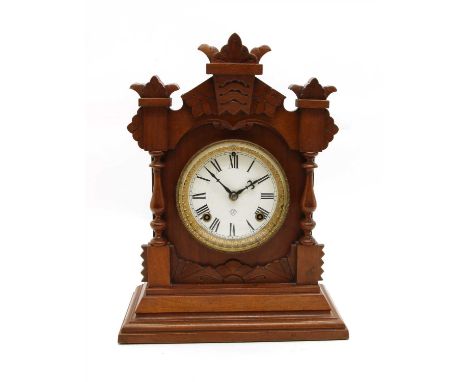 A Victorian walnut striking mantle clock