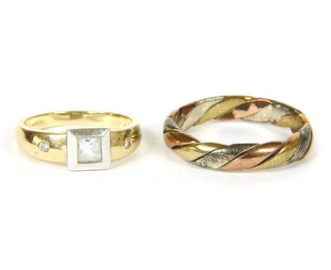 A gold three colour twisted band ring, size T, and a 9ct gold aquamarine and diamond ring, with a square step cut aquamarine,