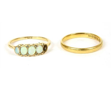 An opal and diamond five stone ring, (one opal deficient) , with a row of graduating oval cabochon opals, with pairs of rose 