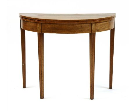 A George III mahogany demi lune card table, the foldover top on moulded square section tapering supports