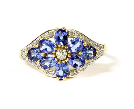A 14ct gold tanzanite and diamond floral cluster ring, with a cluster of brilliant cut diamonds claw set to the centre, to su