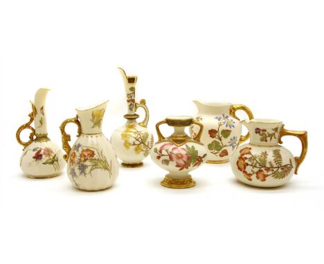 A collection of Royal Worcester ivory and gilt porcelain items, decorated with gilt heightened floral sprays, comprising five