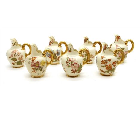 A group of seven Royal Worcester porcelain flat back jugs , with gilt heightened floral decoration, tallest 13.5cm high (7)