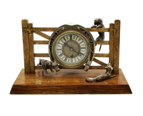 An Edwardian oak brass and silvered hunting gate clock , with horseshoe and hounds, 17cm high
