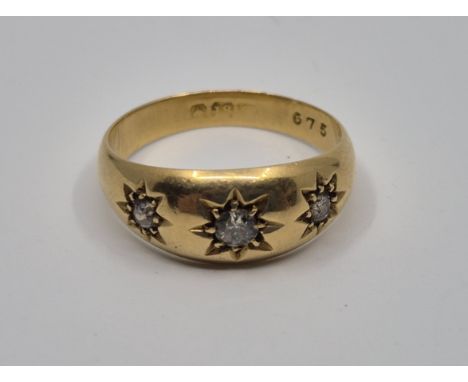 An 18ct. gold and diamond ring, gypsy set three graduated old-cut diamonds, size UK N 1/2. (gross weight 4.6g)&nbsp;
