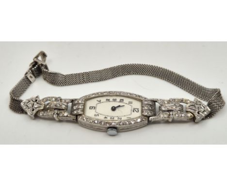 An Art Deco style platinum and diamond set cocktail watch, manual movement, having white Arabic numeral ovoid dial, 16mm wide