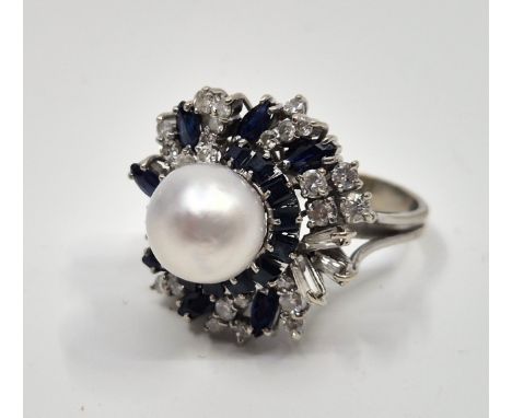 A white metal, sapphire, diamond and cultured pearl cluster ring,&nbsp;having stylised flower mount, diameter 24mm, set centr