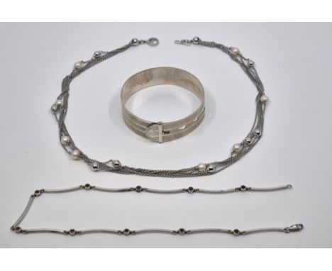 An engine turned adjustable silver bangle fashioned as a belt, by Charles Horner, Chester 1943, together with a&nbsp;silver f