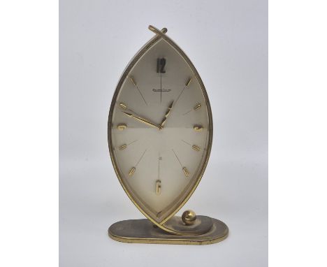 A Jaeger-leCoultre gilt brass mantle clock,&nbsp;of abstract form, having navette shaped dial with applied baton and quarterl