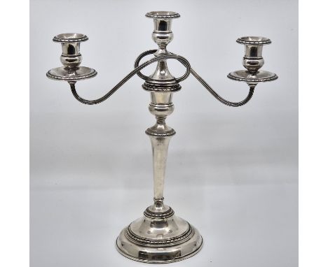 A silver three branch candelabra, by Adie Brothers Ltd, Birmingham 1956, convertible into single candlestick, with weighted b