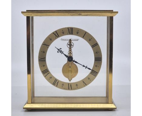 A Jaeger-leCoultre gilt brass mantle clock,&nbsp;having gilt brass Roman numeral chapter ring surrounding visible jewelled Sw