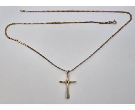 A yellow metal and sapphire pendant cross, set single round cut sapphire to centre (yellow metal assessed as 14ct. gold, gros
