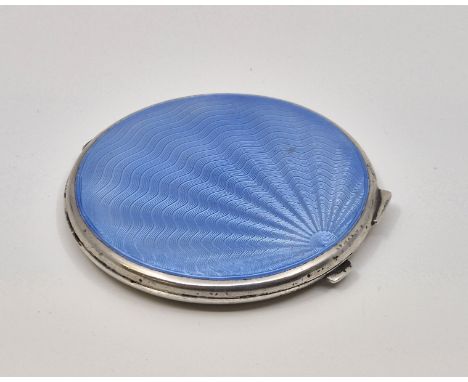 A silver and light blue guilloche enamel compact, by Turner &amp; Simpson Ltd, Birmingham 1947, with engine turned base, diam