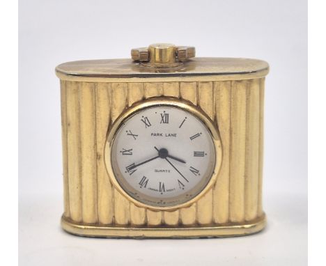 A Park Lane&nbsp;gold plated quartz table clock,&nbsp;having signed circular Roman numeral dial and fluted ovoid gold plated 