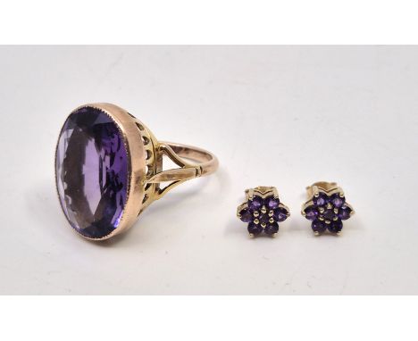 A 9ct. rose gold and amethyst dress ring,&nbsp;rub-over set large single mixed oval cut amethyst (approx. 21mm x 1.6mm x 7mm)