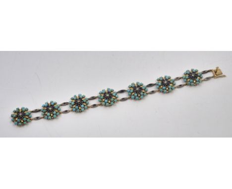 An 18ct. gold, turquoise, diamond and sapphire bracelet,&nbsp;formed from 18ct. yellow gold lobed circular links set single e