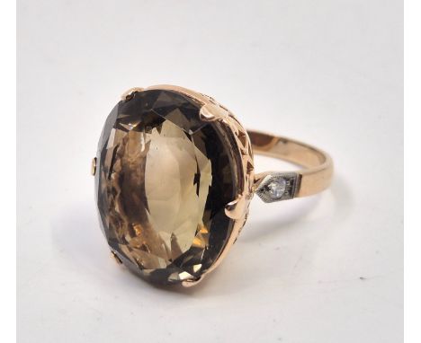 A Russian 14ct. gold, citrine and diamond dress ring, set large mixed oval cut citrine to centre above pierced gallery with e