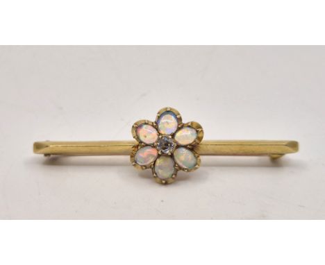 A 15ct. gold, opal and diamond bar brooch, having central flower form mount set old-cut diamond to centre bordered by six ova