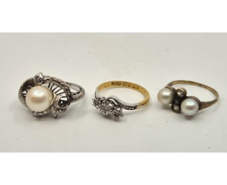 An 18ct. gold and platinum three stone diamond cross-over style ring, illusion set three graduated round brilliant cut diamon