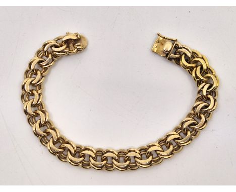 A Cartier 14ct. gold double curb link bracelet, signed to clasp, length 19.5cm. (51.0g)&nbsp;&nbsp;