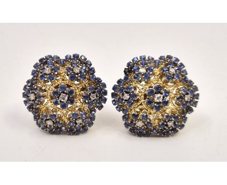 A pair of 9ct. gold, sapphire and diamond floral cluster earrings, having domed hexafoil filigree work mount set seven cluste