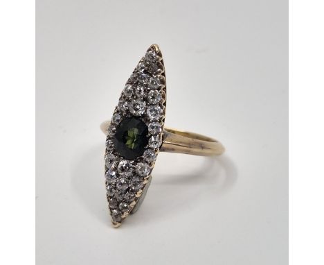 An 18ct. gold, sapphire and diamond ring, the marquise shaped mount set oval mixed cut green sapphire to centre with an estim