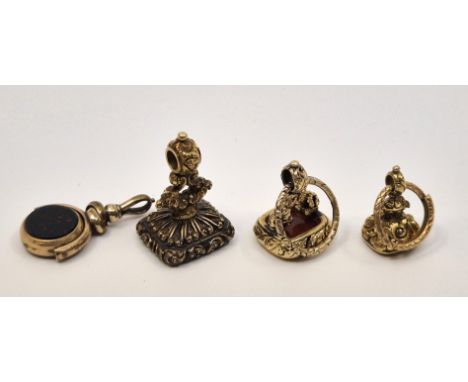 Two 19th century yellow metal mounted carnelian agate fob seals, one intaglio carved Coat of Arms and moto, the other initial