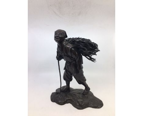 A Japanese Meiji patinated bronze figure of woodcutter.&nbsp;