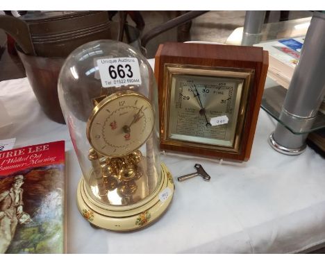 A Bentima floral pattern anniversary clock under glass dome and a vintage barometer.