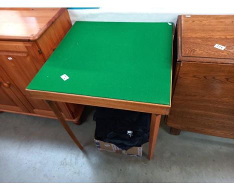 A vintage green felt covered folding card table