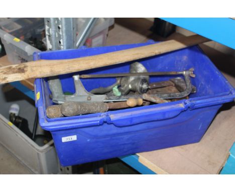 A box of vintage tools including a new axe handle 