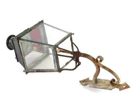 A Victorian copper clear and coloured glass panelled street lamp, on iron bracket, 134cm overall