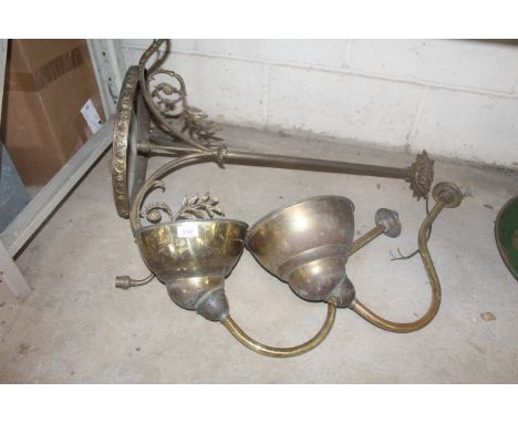 A brass chandelier light fitting and two brass coloured wall light fittings