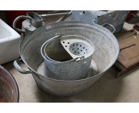 A galvanised slop bucket / planter and a twin handled galvanised bath