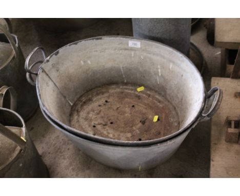 Two twin handled galvanised baths, one drilled out as a planter