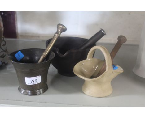 Three various pestle and mortars, cast iron, brass and ceramic