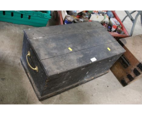 A wooden trunk with twin brass handles