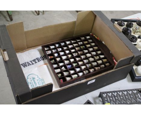 A display rack containing 72 various ceramic thimbles etc. and a quantity of advertising packets