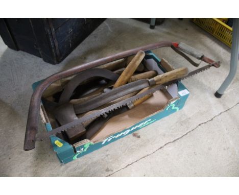 A box of hand tools and a bow saw