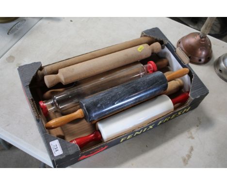 A box containing various rolling pins including one marble, one glass, one ceramic and eight wooden