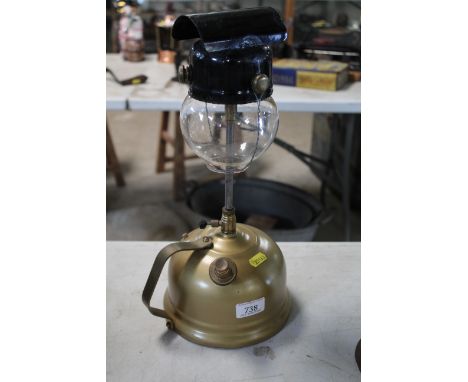 A Tilley table lamp with damaged glass