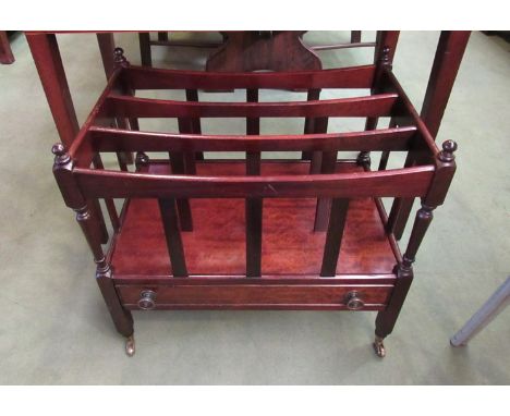 A George III revival mahogany three division Canterbury, the turned finial supports over a single base drawer and brass cup c