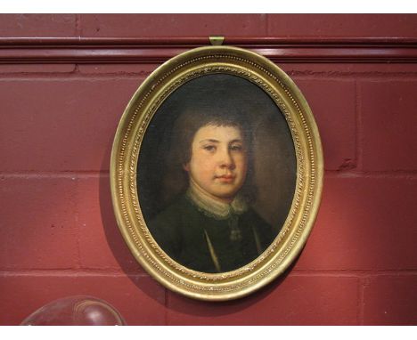 An early 18th Century English School portrait of a young man, Thomas Dorham in 1714 - aged 10 - in an oval gilt frame, 44 x 3