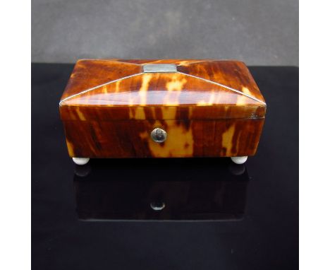 A 19th Century trinket box on bun feet