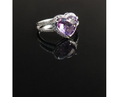 An 18ct white gold diamond and amethyst ring, the heart shaped amethyst framed by diamonds   