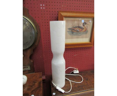 A cylindrical white glass table lamp with leaf detail 