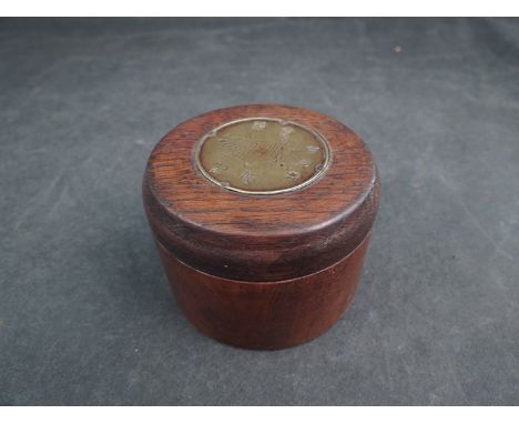 An Oriental lidded compass with brass plaque to top 